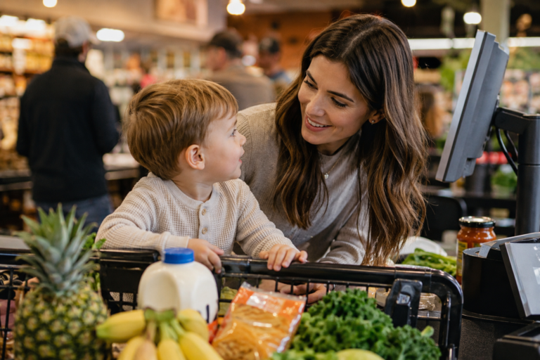 Parent using calm communication with toddler during grocery shopping