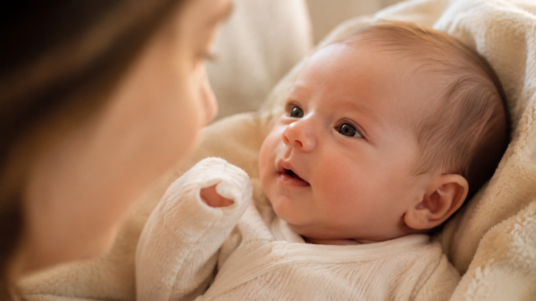 Newborn making eye contact with parent — early communication development