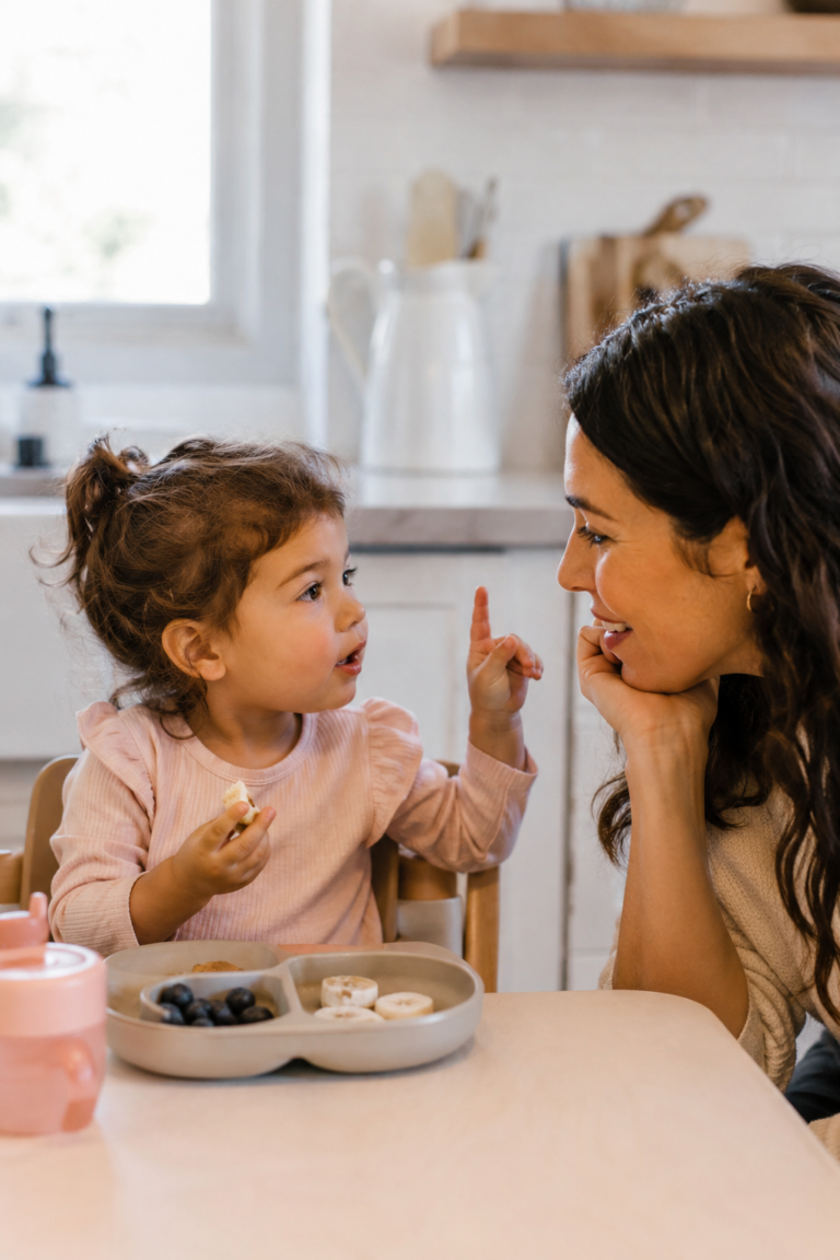 Toddler in the two-word stage communicating with parent during play